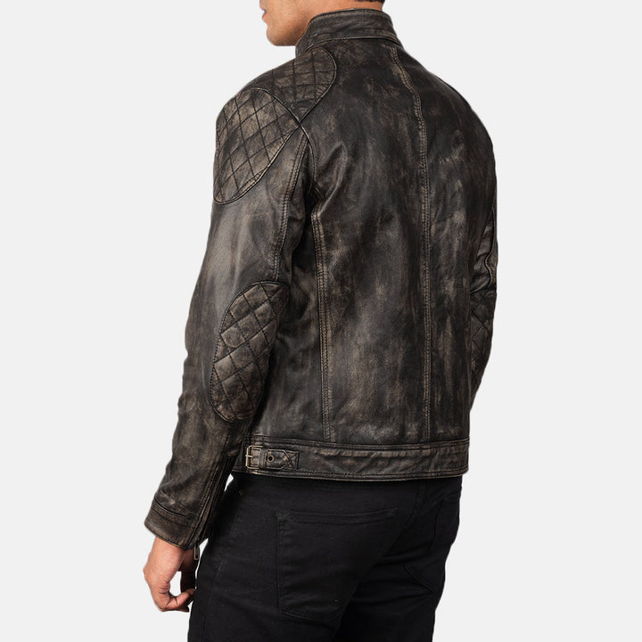 Dark leather jacket with quilted details on a white background